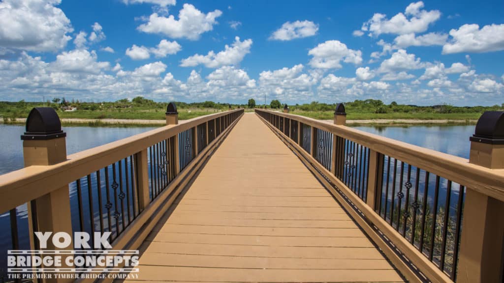 Ave Maria University Pedestrian Bridge - Ave Maria, FL | York Bridge Concepts - Timber Bridge Builders