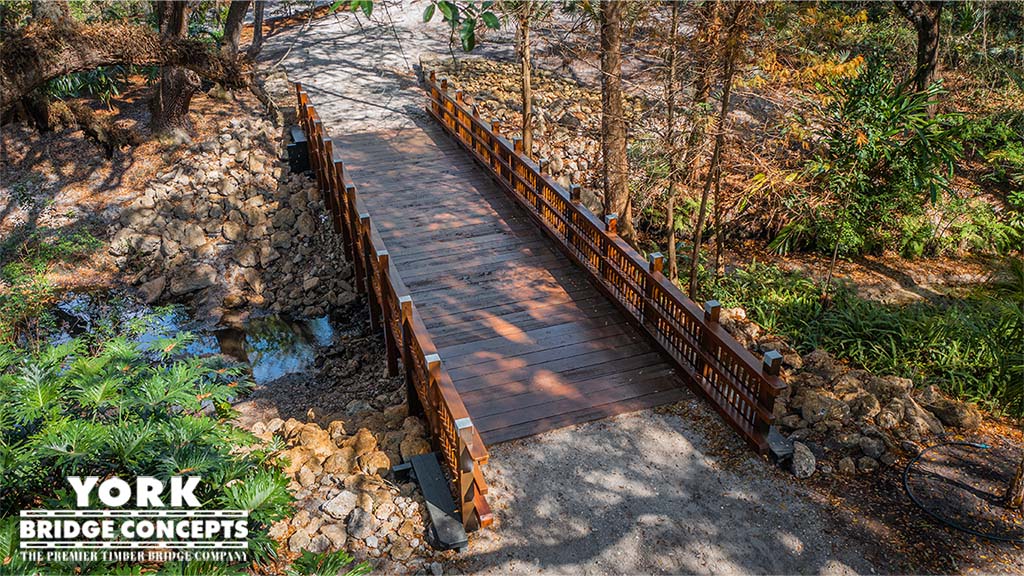 Design of a Stress Ribbon Glulam Footbridge Across a Steep Forest