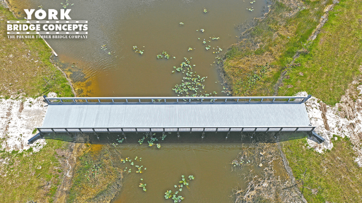 Over head and side of Avenir Timber pedestrian bridge for the Avenitr community project. Palm Beach Gardens, FL